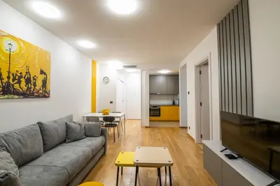 a living room with a couch and a table at City Center - The Port Apartment with Terrace & Garage in Belgrade