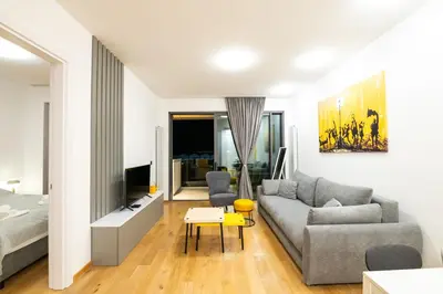 a living room with a couch and a bed at City Center - The Port Apartment with Terrace & Garage in Belgrade
