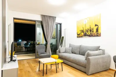 a living room with a couch and a table at City Center - The Port Apartment with Terrace & Garage in Belgrade