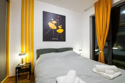 a bedroom with a bed with two towels on it at City Center - The Port Apartment with Terrace & Garage in Belgrade