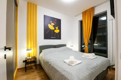 a bedroom with a bed with two towels on it at City Center - The Port Apartment with Terrace & Garage in Belgrade
