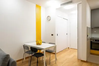 a small kitchen and dining room with a table and chairs at City Center - The Port Apartment with Terrace & Garage in Belgrade