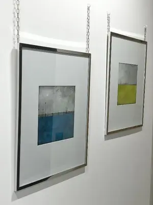 two framed photographs are hanging on a wall at Apartment Silicon Valley in Belgrade