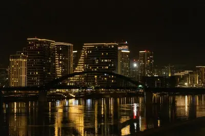 a city skyline at night with a bridge over the water at Apartment Silicon Valley in Belgrade