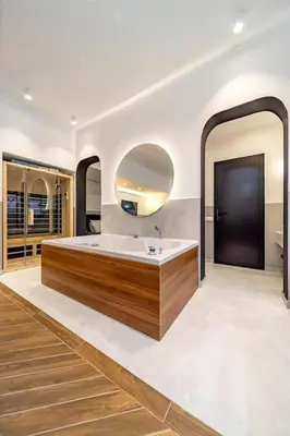 a bathroom with a tub and a large mirror at Kovac Spa Belgrade Apartment in Belgrade