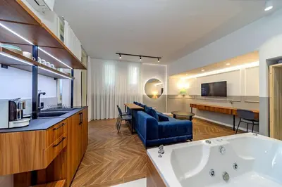 a large kitchen and living room with a tub at Kovac Spa Belgrade Apartment in Belgrade