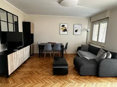 a living room with a couch and a table at Ritual Belgrade Apartment in Belgrade