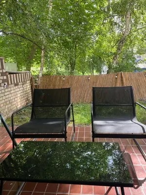 two black benches sitting on a brick patio at Ritual Belgrade Apartment in Belgrade