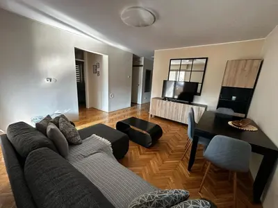 a living room with a couch and a table at Ritual Belgrade Apartment in Belgrade