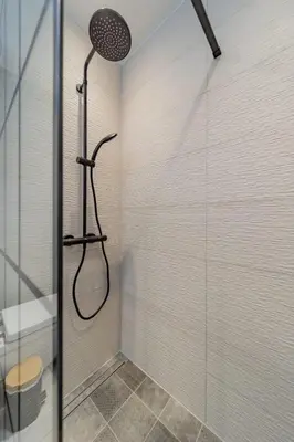a bathroom with a shower with a glass door at Ritual Belgrade Apartment in Belgrade