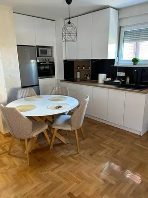 a kitchen with a table and chairs in a kitchen at Ana in Smederevo