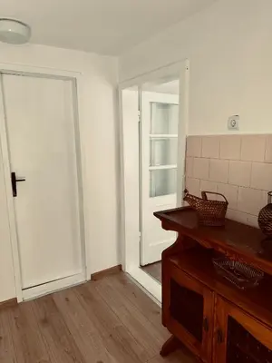 an empty room with a door and a wooden table at Stan na dan in Belgrade
