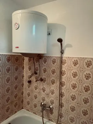 a water tank on the wall of a bathroom at Stan na dan in Belgrade