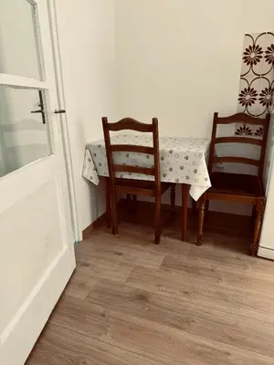 a table and two chairs sitting next to a table and a table and chairs sidx at Stan na dan in Belgrade
