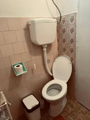a bathroom with a toilet and a water tank at Stan na dan in Belgrade
