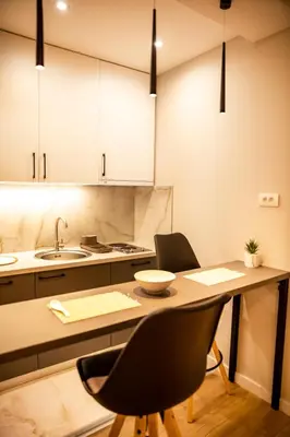 a kitchen with a table and chairs and a sink at Aleksa&Una in Ledine