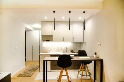 a kitchen with a table and two chairs at Aleksa&Una in Ledine