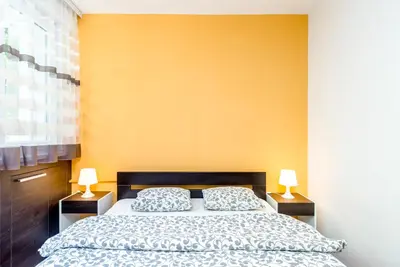 a bedroom with a bed and two lamps on tables at Apartments King Milan, City Center in Belgrade