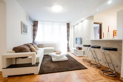 a living room with a couch and a table at Apartments King Milan, City Center in Belgrade