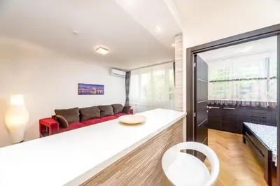 a living room with a red couch and a table at Apartments King Milan, City Center in Belgrade
