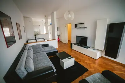 a living room with a couch and a flat screen tv at Viktorija Apartment in Belgrade