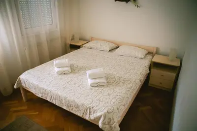 a bedroom with a bed with two towels on it at Viktorija Apartment in Belgrade