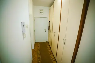 an empty hallway with a door and a room with a hallway at Viktorija Apartment in Belgrade