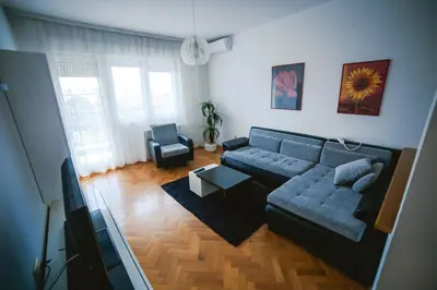 a living room with a couch and a tv at Viktorija Apartment in Belgrade
