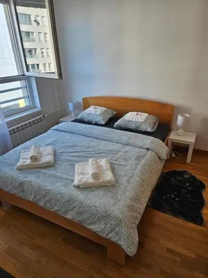 two towels on a bed in a bedroom at Star Belville in Novi Beograd