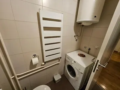 a small bathroom with a washing machine in it at Star Belville in Novi Beograd