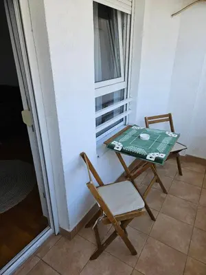 a table and two chairs sitting on a balcony at Star Belville in Novi Beograd