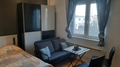 a bedroom with a bed and a chair and a table at Skadarlija Central in Belgrade