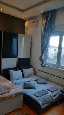 a bedroom with two beds in front of a window at Skadarlija Central in Belgrade