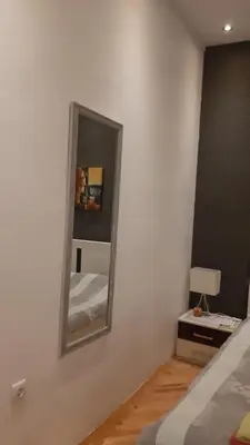 a mirror on the wall of a bedroom at Skadarlija Central in Belgrade