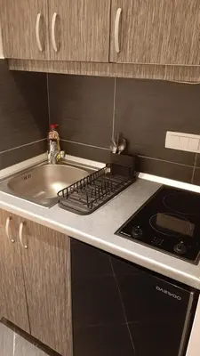 a kitchen with a sink and a stove at Skadarlija Central in Belgrade