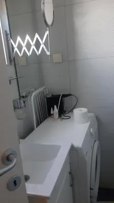 a white bathroom with a sink and a mirror at Skadarlija Central in Belgrade