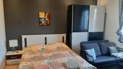 a bedroom with a bed and a blue chair at Skadarlija Central in Belgrade