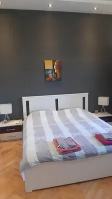 a bedroom with a bed with a striped comforter at Skadarlija Central in Belgrade