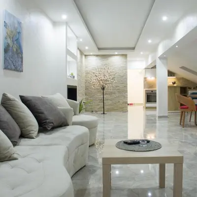 a living room with a white couch and a table at New Moment Lux 2 in Žarkovo