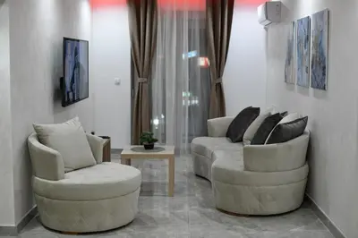 a living room with two chairs and a table at New Moment Lux 2 in Žarkovo