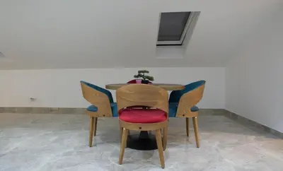 a table with chairs with a potted plant on it at New Moment Lux 2 in Žarkovo
