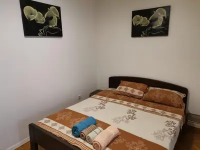 a bed in a room with two pictures on the wall at Belgrade on water - City center in Belgrade