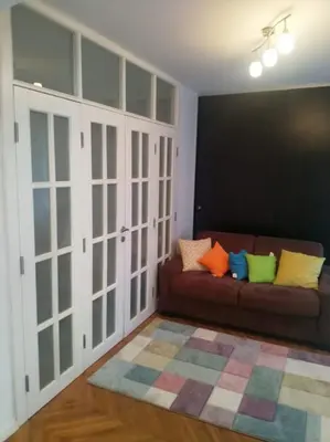 a living room with a couch with colorful pillows at Belgrade on water - City center in Belgrade
