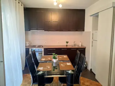 a dining room with a table and chairs in a kitchen at Belgrade on water - City center in Belgrade