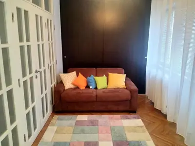 a brown couch with colorful pillows on it in a room at Belgrade on water - City center in Belgrade