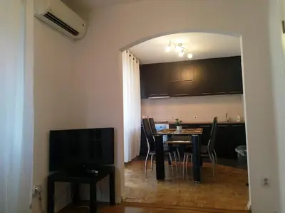 a dining room with a table and chairs and a television at Belgrade on water - City center in Belgrade