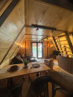 a living room with a wooden table in a house at Apartman Durtanoski 1 in Mali Mokri Lug