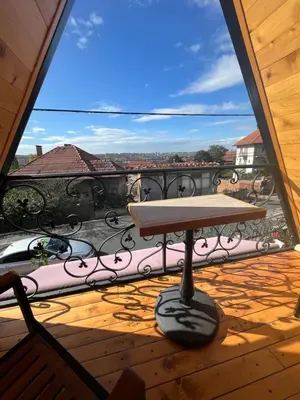 a table on a balcony with a view at Apartman Durtanoski 1 in Mali Mokri Lug