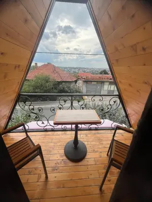 a wooden balcony with a table and two chairs at Apartman Durtanoski 1 in Mali Mokri Lug