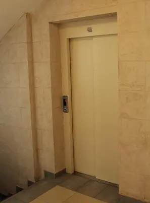 a door in a building with a sign on it at Aura Apartment - Lovely Apartment with Garage Parking in Belgrade